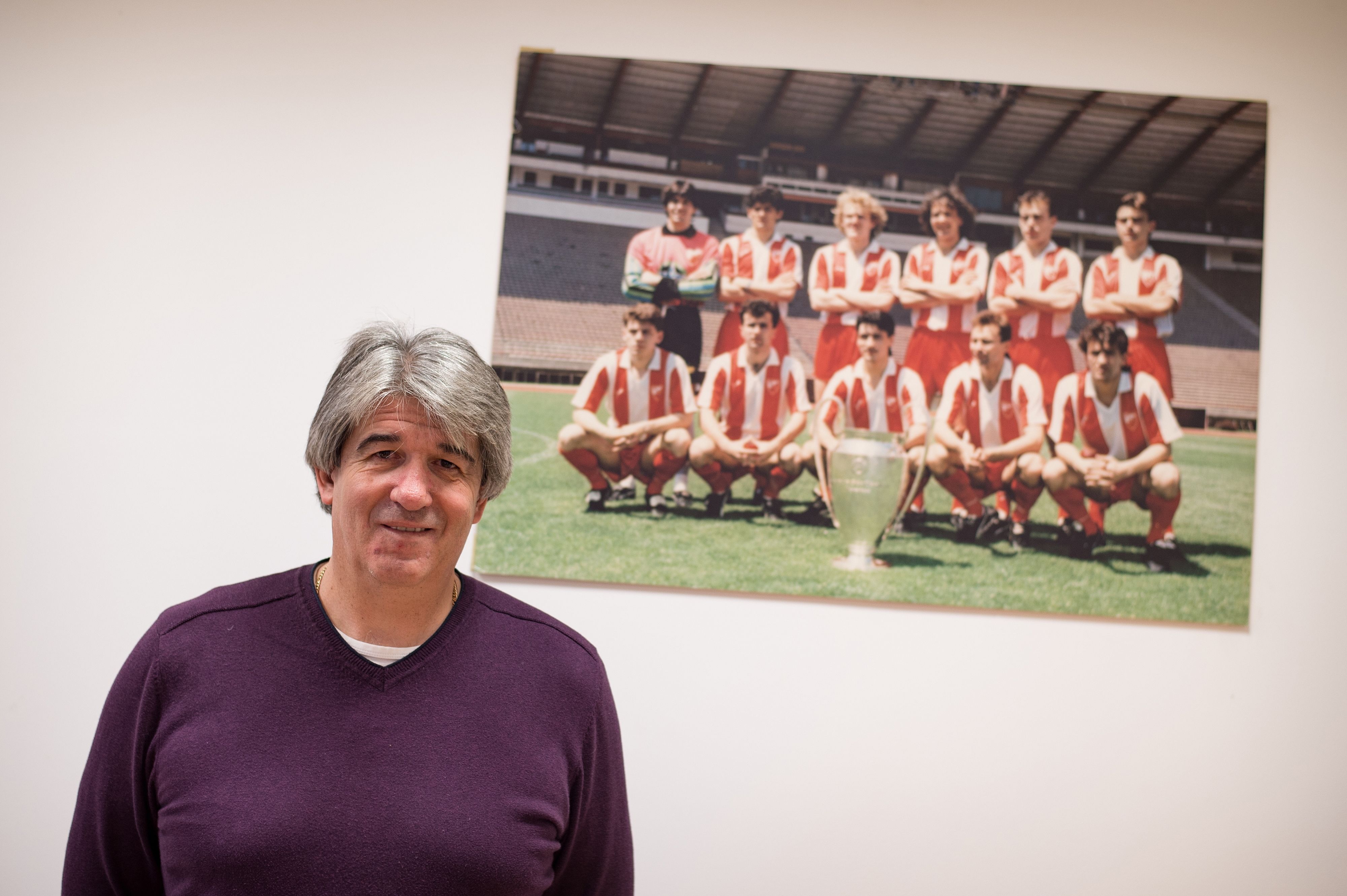 Stevan Stojanovic poses in front of a picture of Red Star Belgrade's European Cup-winning team of 1991.