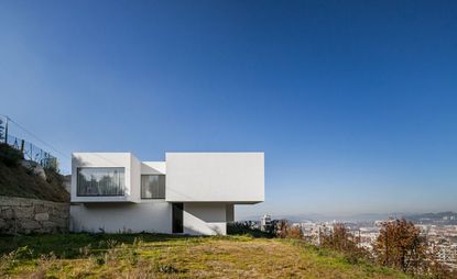 Casa AA perched on a hill overlooking the town. photographed during the day