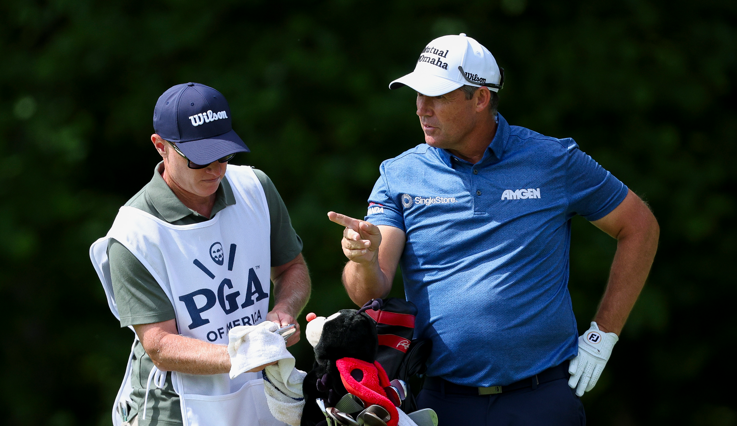 Padraig Harrington speaks to his caddie