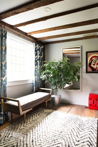 living room with aged wood floor planks and rug