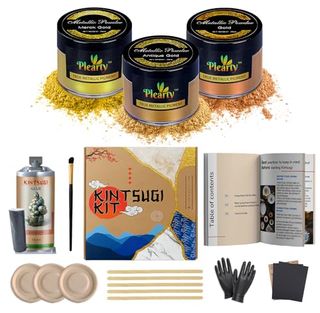 A kintsugi repair kit with three metal powder polishes, epoxy resin, and gloves.