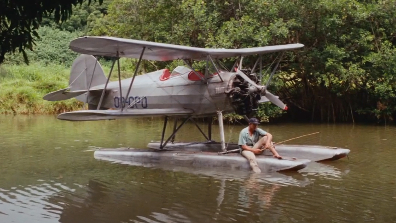 A float plane sitting in the water with the tail number OB-C3PO