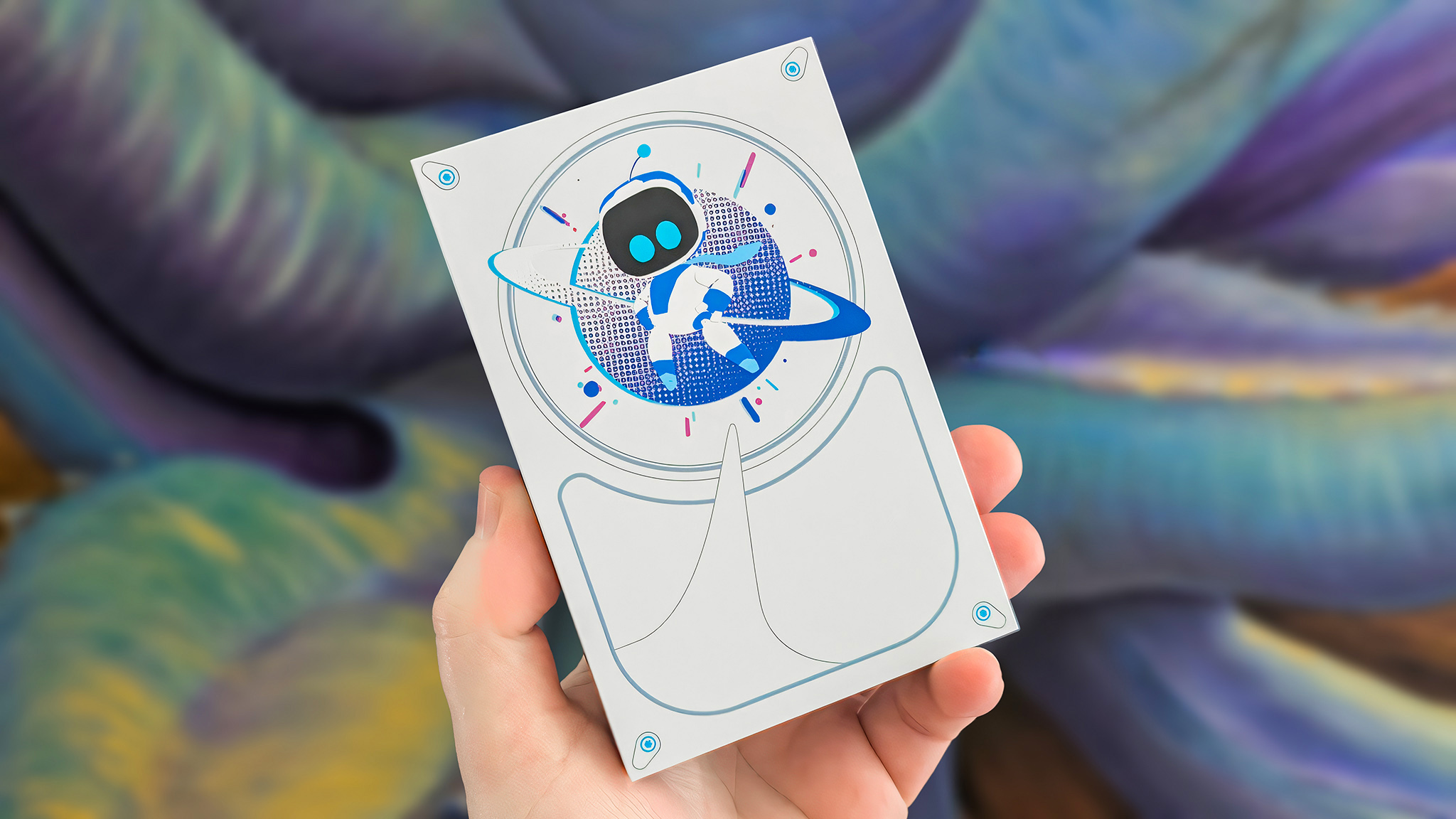 A hand holding the Seagate Astro Bot Limited Edition Game Drive in ftong of a colorful background. 