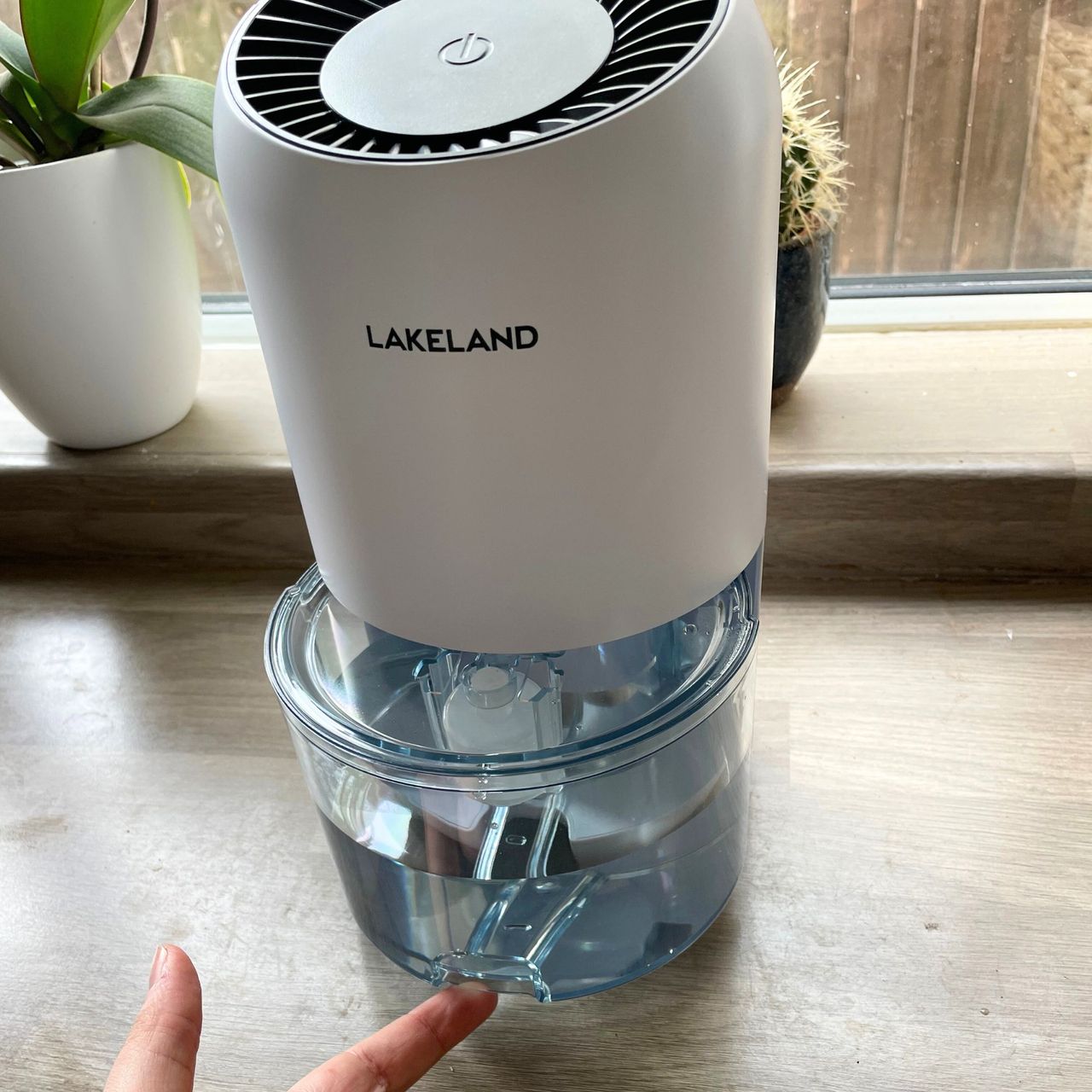 Lakeland dehumidifier with a full water tank sitting on kitchen worktops