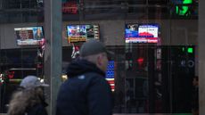 Pedestrians passing by Nasdaq headquarters in Times Square 