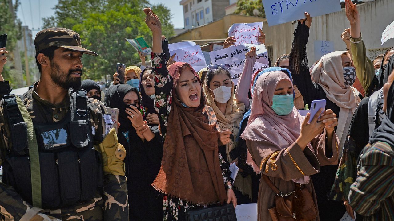 A Taliban fighter watches over a protest led by Afghan women in Kabul