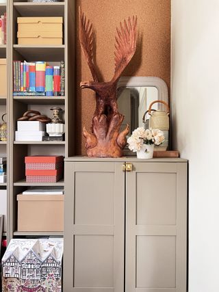 Built-in shelving and cabinet painted in a beige color