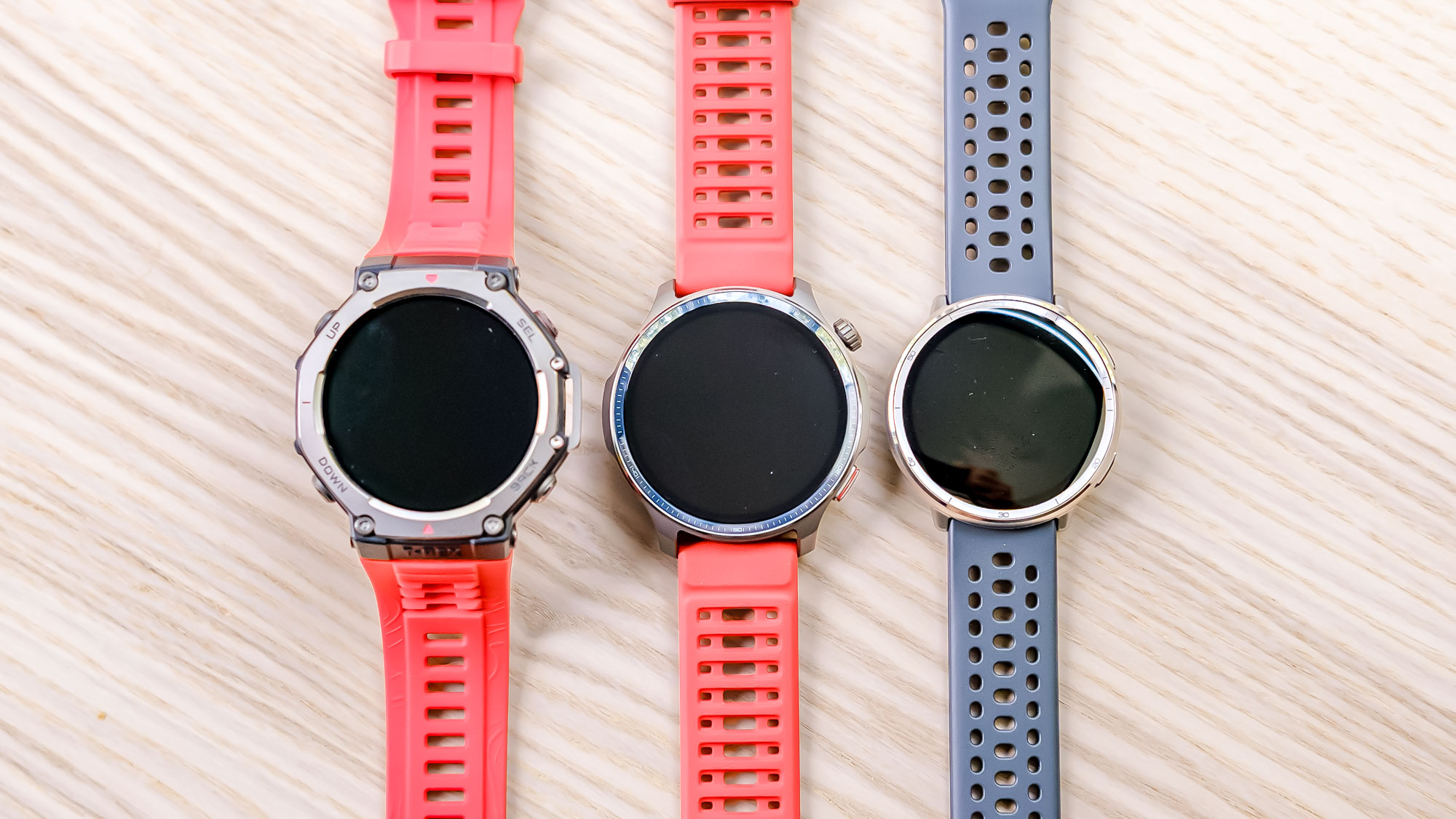 Close-up of the Amazfit Balance 2 smartwatch sitting in between the Amazfit T-Rex 3 (left) and Amazfit Active 2 (right)
