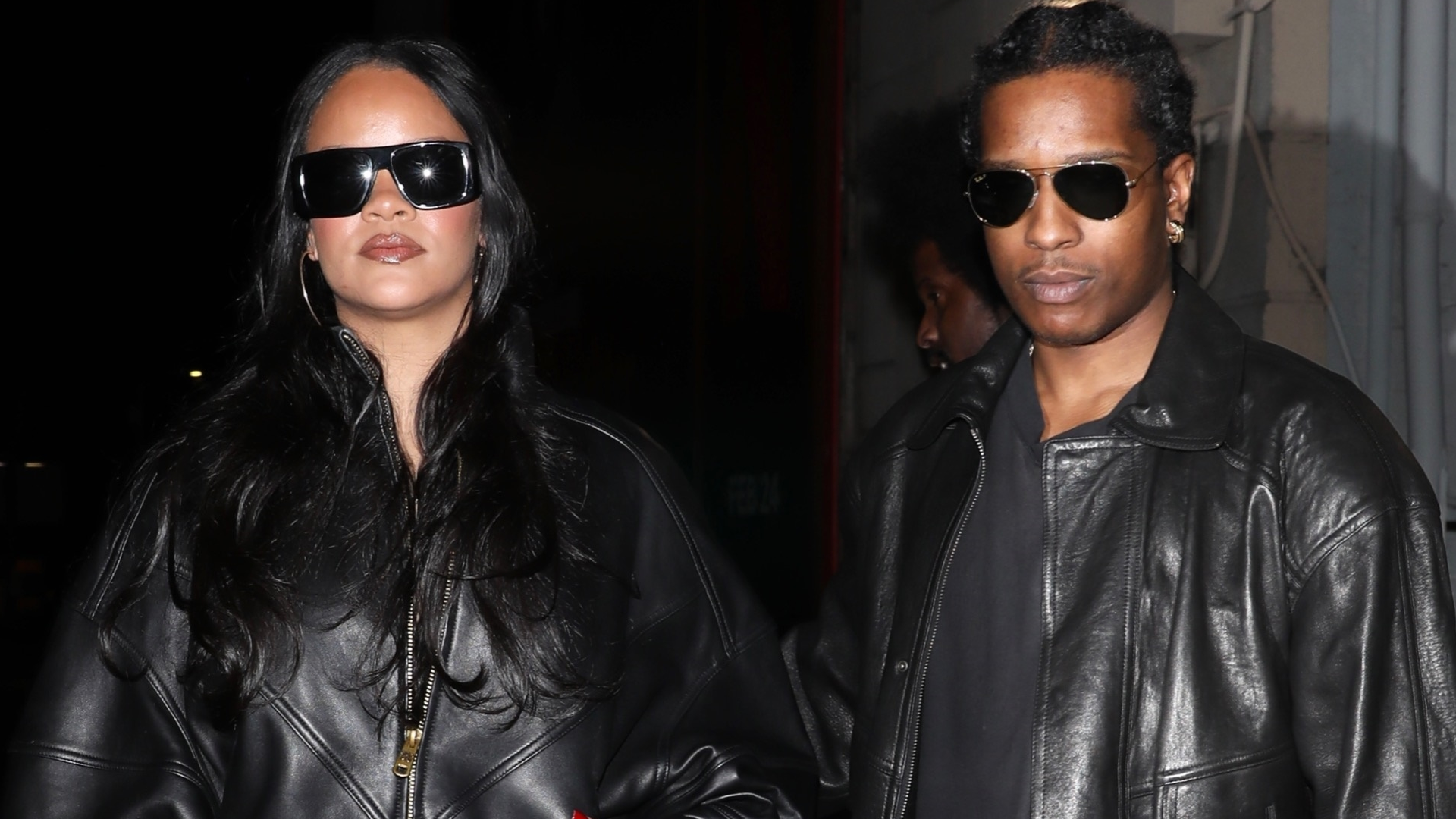 Rihanna and A$AP Rocky coordinated in black leather jackets, with RiRi in over-the-knee leather boots