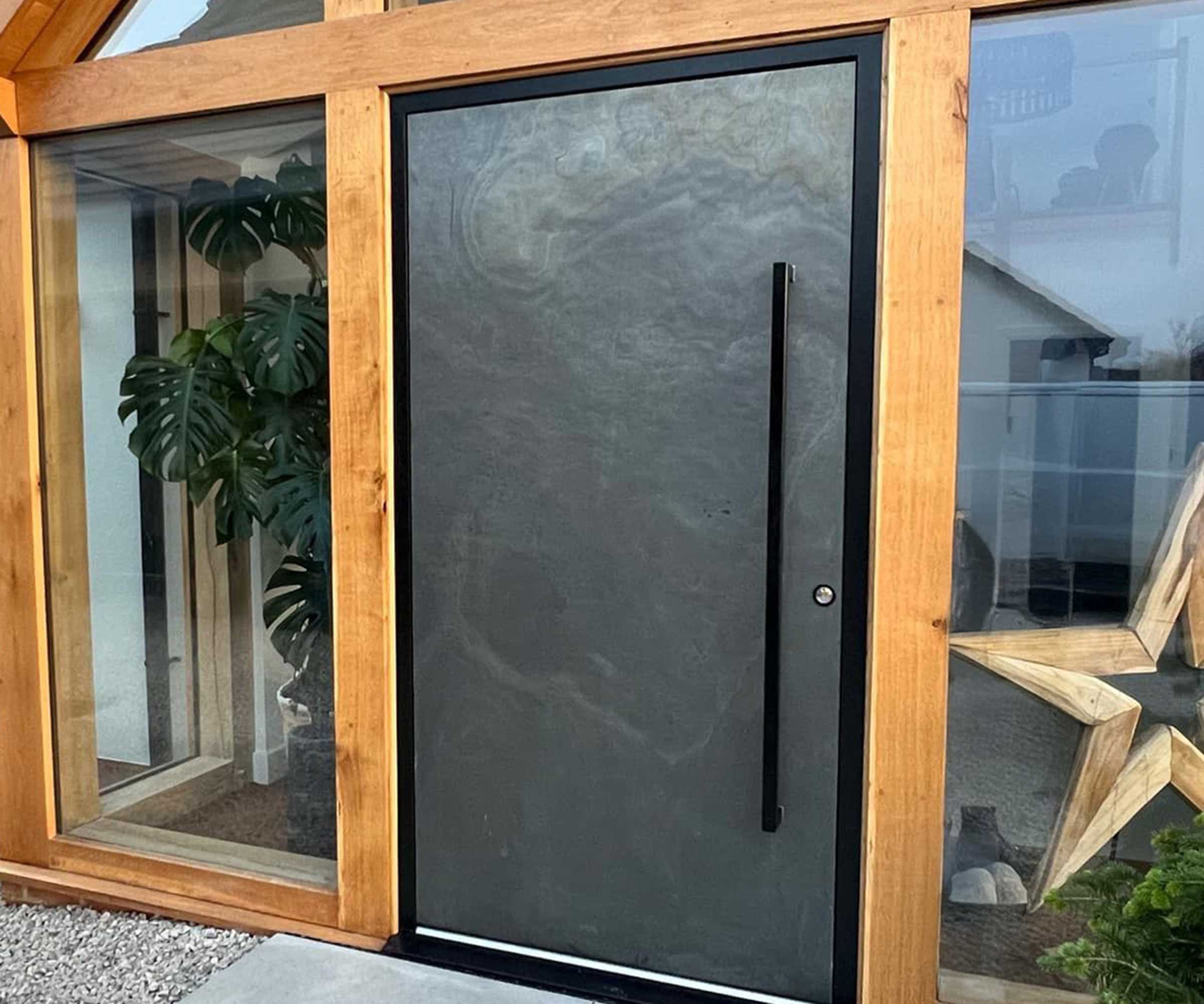 slate-effect modern front door on a contemporary glazed porch entrance