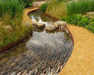 garden stream with a slate stone bed and corten steel borders designed by Helen Elks_Smith
