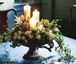 Green panelled room, with three candles in a floral centrepiece