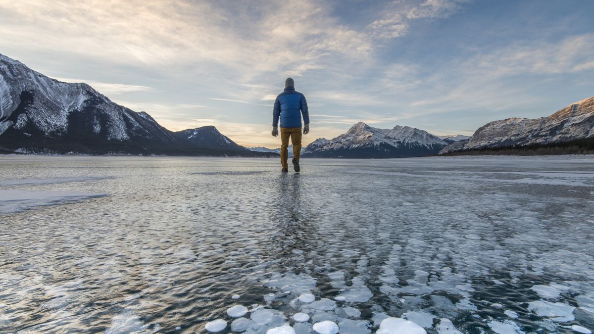 A man standing on a frozen lake