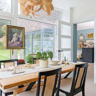 dining room with wooden table and black dining chairs