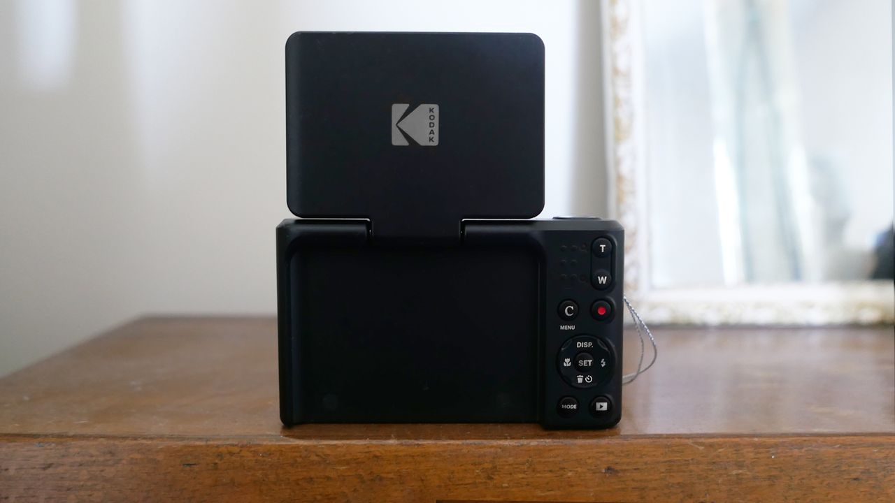 Kodak Pixpro C1 with a flip screen displayed on a wooden table, showcasing its sleek design and user-friendly controls.