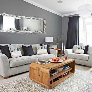living are with grey wall and sofa with coffee table