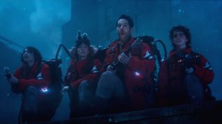Finn Wolfhard Carrie Coon Paul Rudd and McKenna Grace crouch armed with proton packs in Ghostbusters: Frozen Empire.