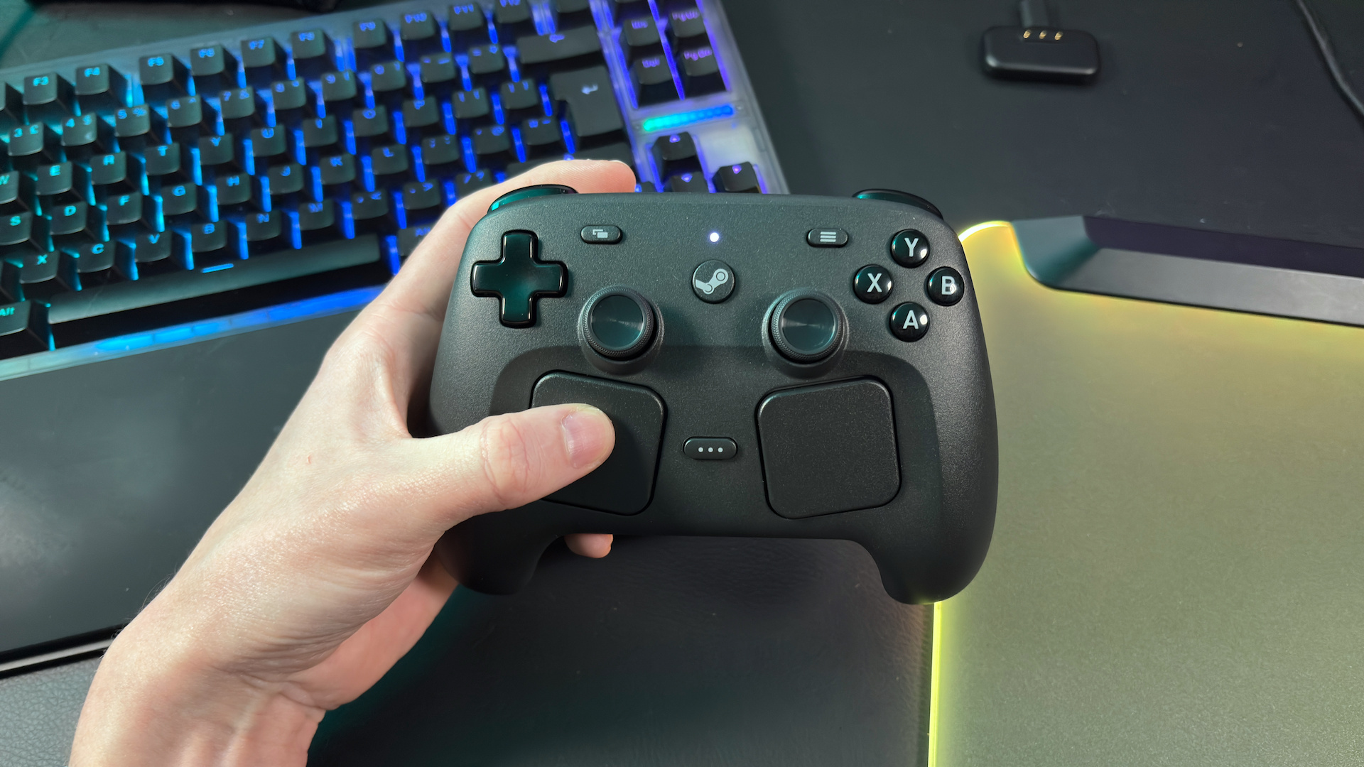 The Steam Controller on a desk during a teardown, with various parts removed.