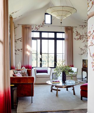 living room with ombre drapery, rust sofa and tree mural