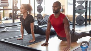 Man and women do the divebomber press-up