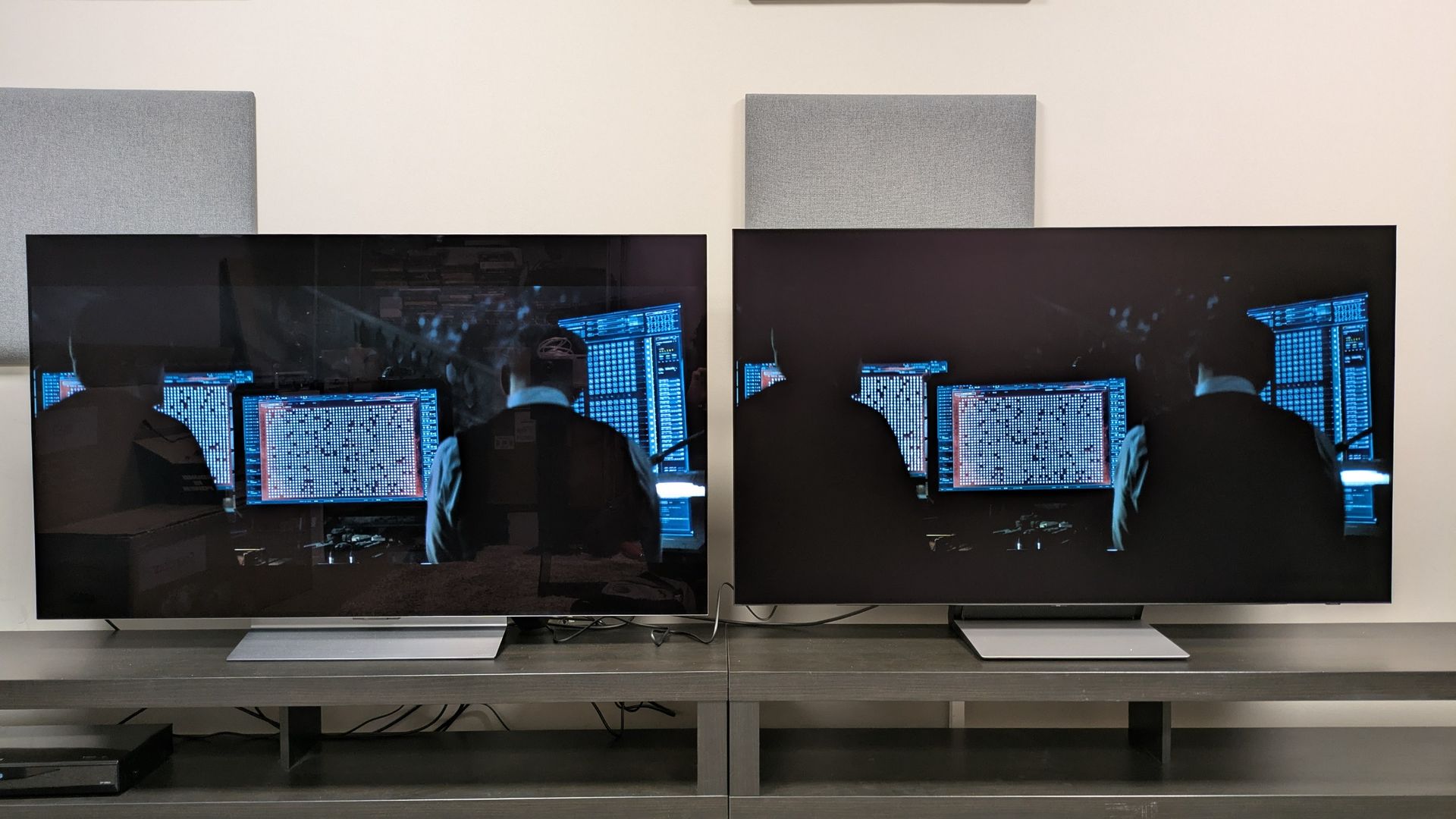 LG C6 (left) and Samsung S90H (right) showing shot of Bruce and Alfred in the Batcave from The Batman, in bright room conditions. The S90H does a better job reducing reflections