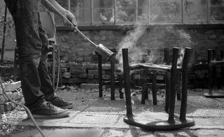 Furniture pieces being burned and treated with wax
