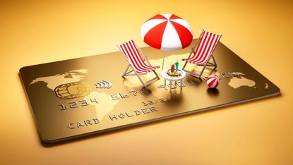 Beach chairs with table and cocktails and umbrella on a large golden credit card 