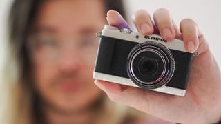 Photographer James Artaius holding the Olympus Stylus SH-3