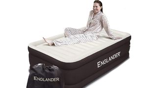 Woman in pyjamas sitting on Englander air mattress
