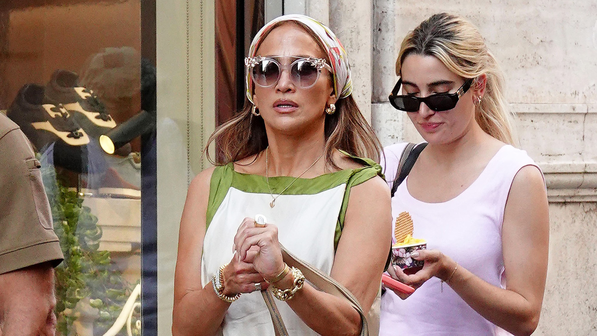 Jennifer Lopez wearing a scarf dress with a head scarf and metallic gold flip-flops in Rome, Italy