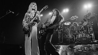 Alex Lifeson and Geddy Lee from Canadian group Rush perform live on stage in Springfield, Massachusetts, 9th December 1976 during their All The World's a Stage tour.