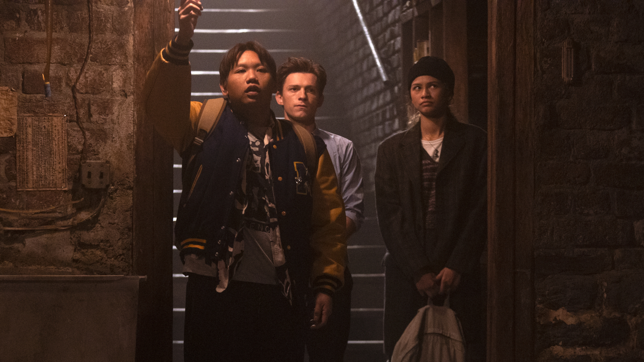 Jacob Batalon leads the way into a dark room with Tom Holland and Zendaya following in Spider-Man No Way Home.