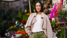 Eva Chen with a paper cut bob wearing a beige long coat, a white t-shirt, green leather pants, pointy shoes, outside Koche x Pucci, during Milan Fashion Week Fall/Winter 2020-2021 on February 20, 2020 in Milan, Italy.