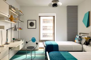 a twin bedroom with bright blue accents