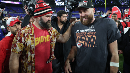 Travis Kelce #87 of the Kansas City Chiefs celebrates with his brother Jason Kelce after a 17-10 victory against the Baltimore Ravens in the AFC Championship Game at M&T Bank Stadium on January 28, 2024 in Baltimore, Maryland. 
