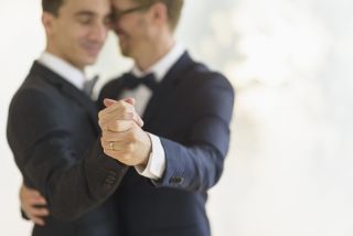 A newly married gay couple enjoying their first dance - which is allowed under new lockdown wedding rules
