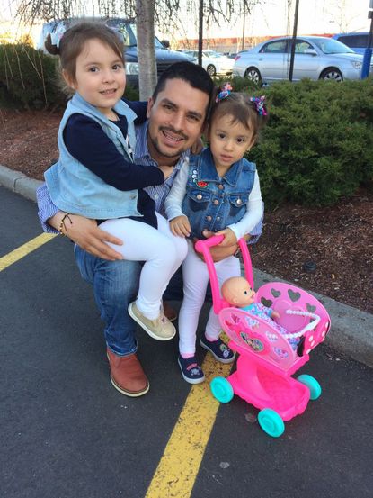 Pablo Villavicencio poses with his two daughters