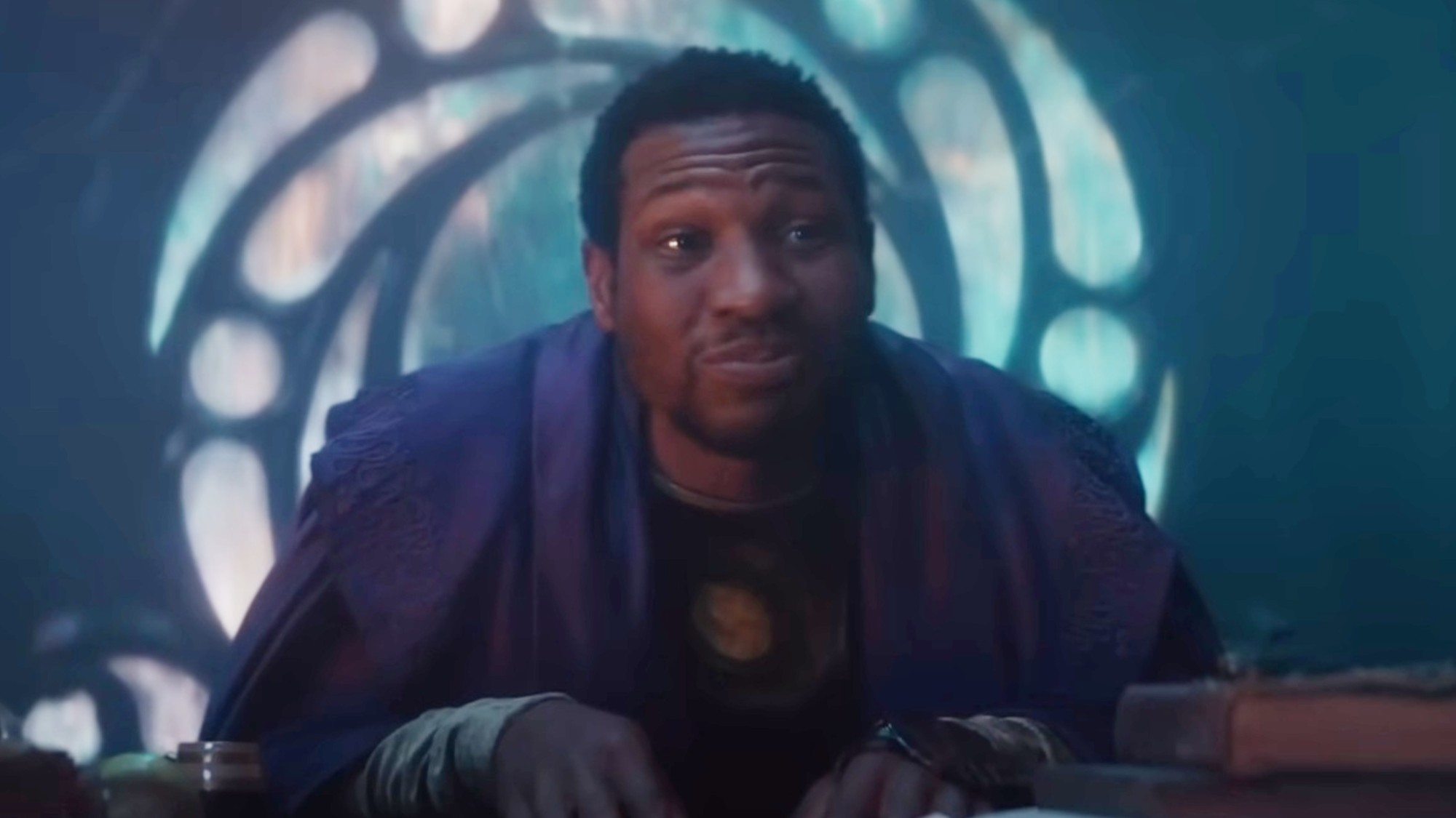 Jonathan Majors sitting in a chair as He Who Remains in Loki