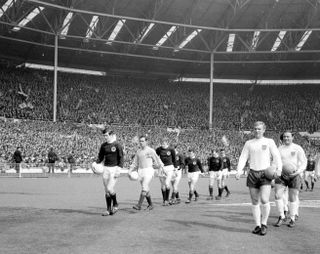 John Greig and Bobby Moore lead out the teams