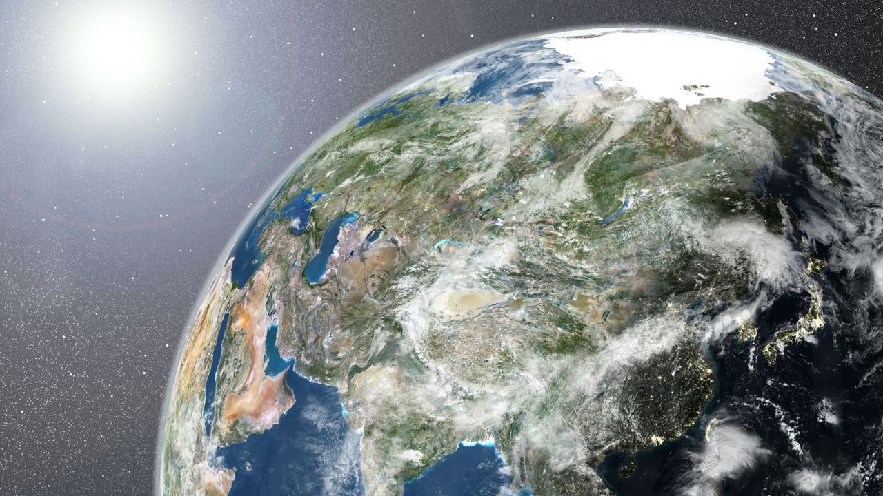 A satellite image of the Earth from space with the Sun shining on it