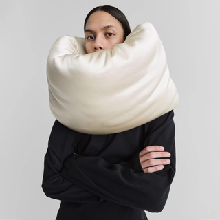 a model wears a phoebe philo neck pillow