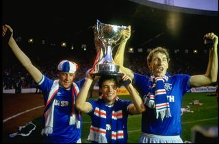 Terry Butcher (right) all of Rangers celebrate with the Skol Cup trophy after the final against Celtic in Scotland. Rangers won the match 2-1