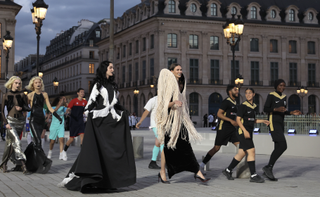 Karlie Kloss walking in Paris, France with friends.