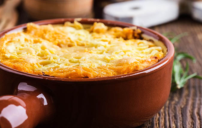 Shepherd&#039;s pie, traditional British dish with minced meat and mashed potato on rustic wooden table