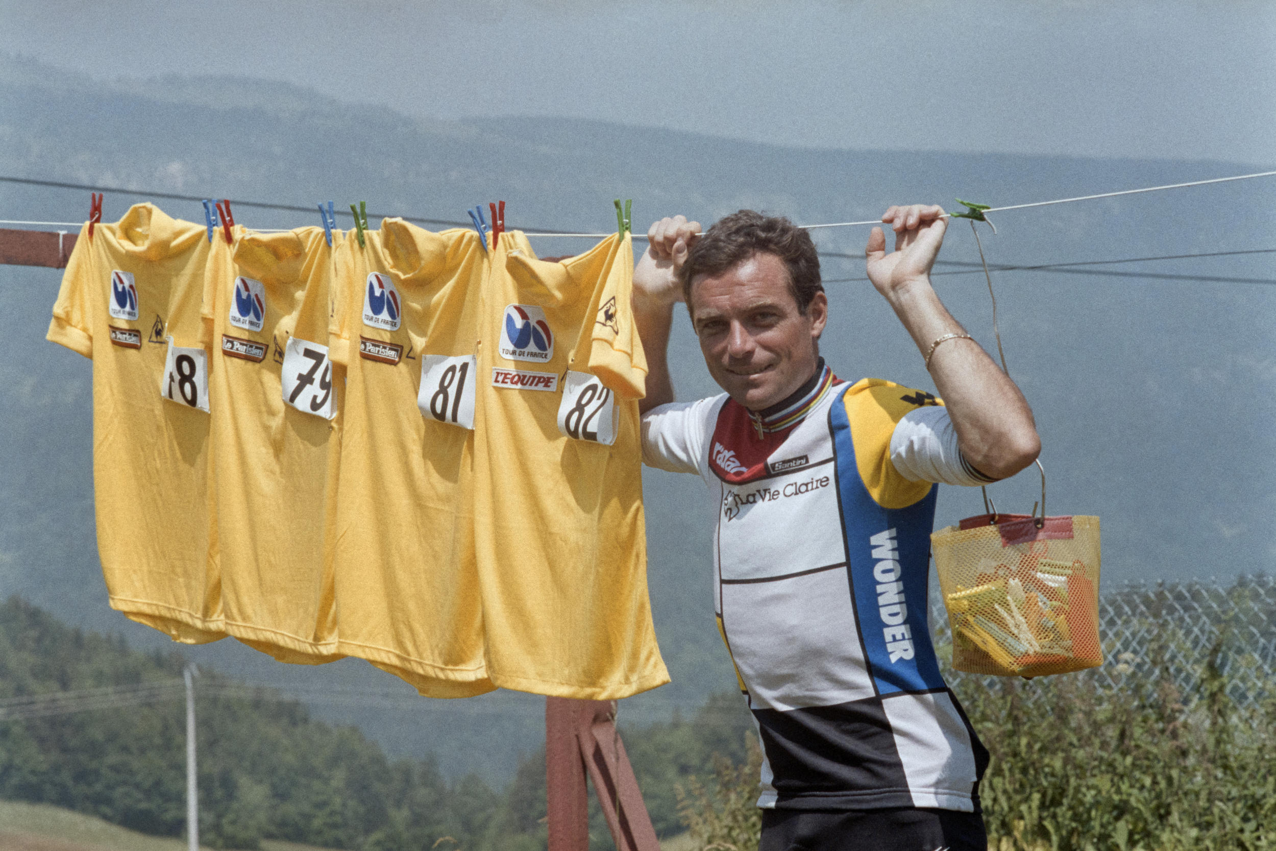 Bernard Hinault poses with four yellow jerseys