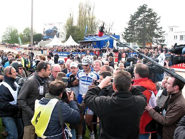 Winner Tom Boonen just crashed into the arms of his brother. One second later some press people crashed as well.