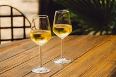 Two glasses of white wine on table