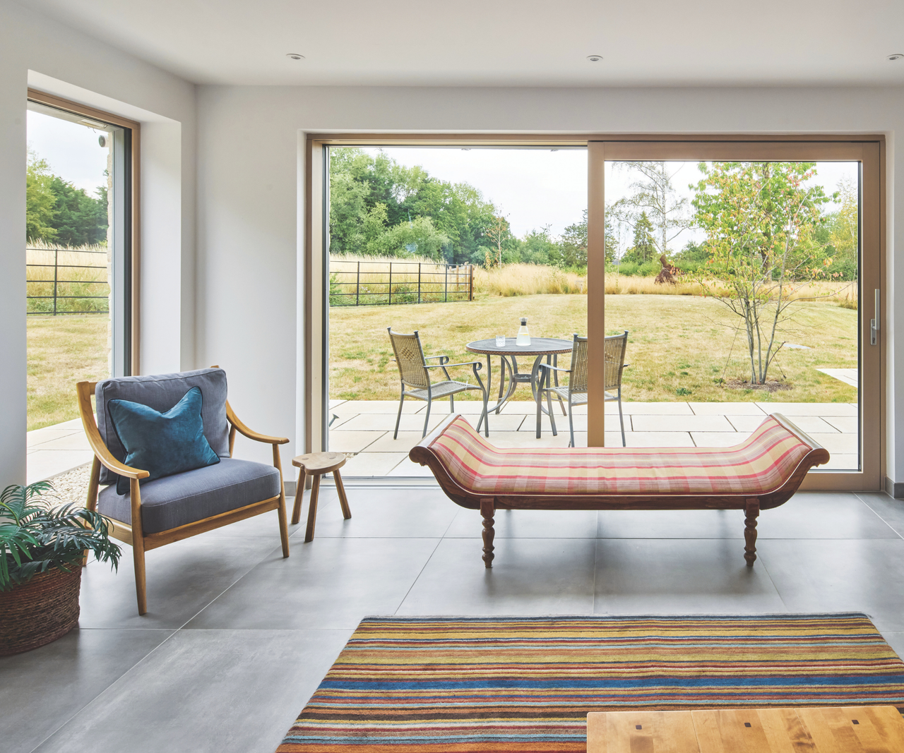 Seating in the living area with sliding doors overlooking patio and garden area