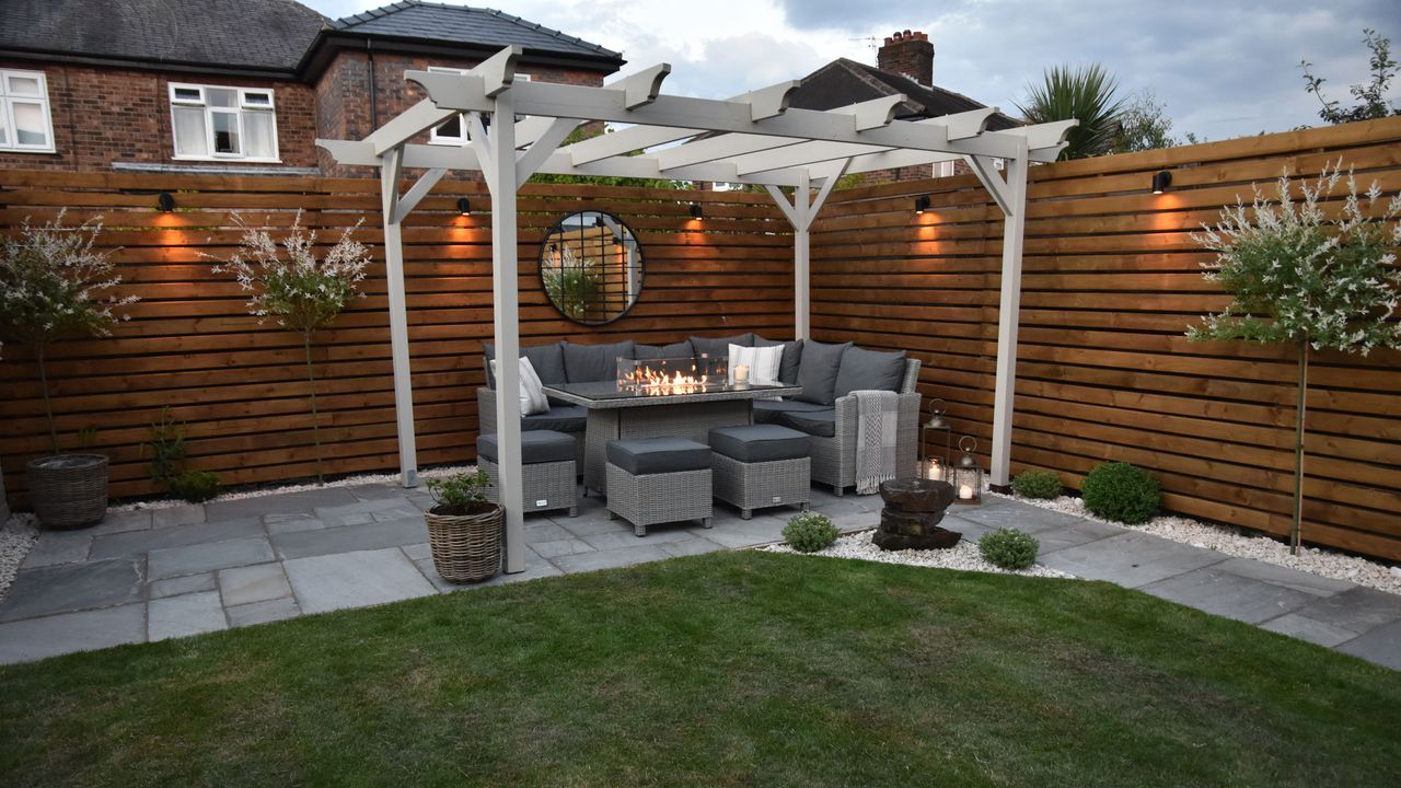 pergola with outdoor sofa in a back garden