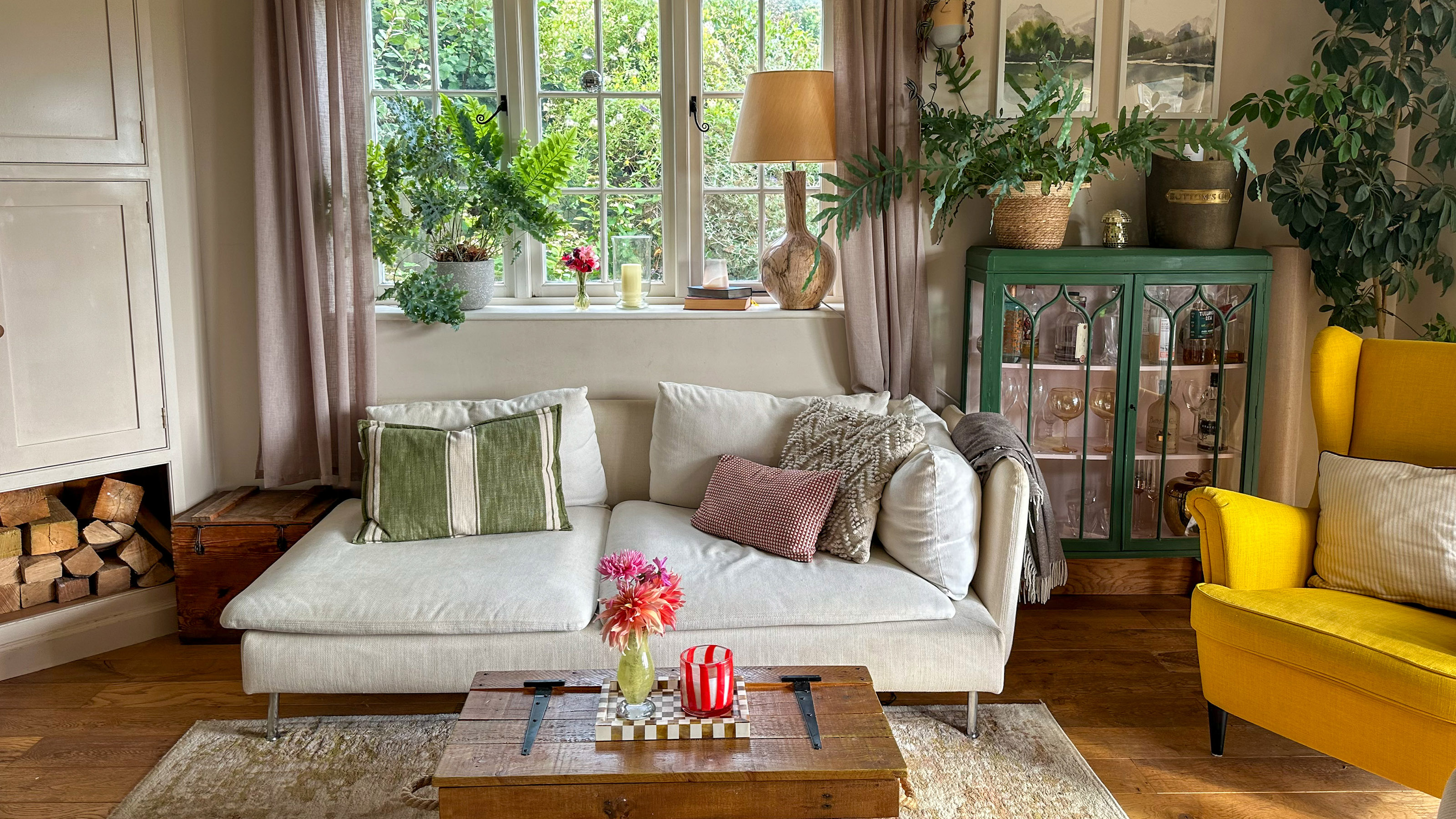 Country-style living room with white sofa, lots of cushions and yellow chair
